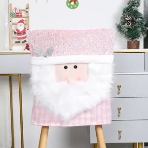 Housse de chaise de Noel Pere Noel sequins roses pour decoration de salle a manger de fete.