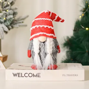 Detailed view of cute Christmas gnome plush toy with red hat and braids for holiday decor.