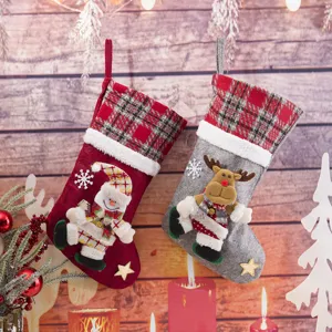 Christmas stocking gift bags with cute snowman and reindeer pendants, perfect for holiday tree decor.