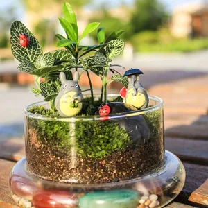 Macro view of a miniature garden with moss and decorative figurines