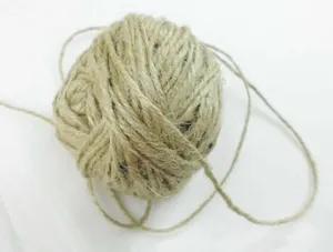 Detailed shot of natural jute twine ball, perfect for DIY crafts and hanging vases.