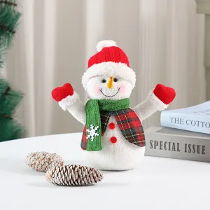 Cute Christmas plush snowman doll holiday decoration ornament with red hat and green scarf.