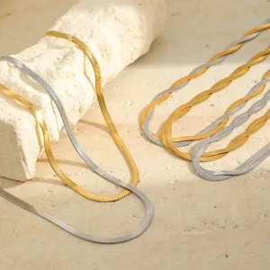 Close-up detail of 18K gold and silver plated stainless steel herringbone snake chain necklaces