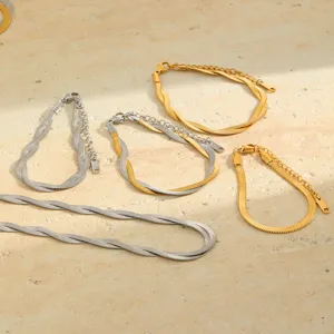 Close-up view of elegant gold and silver braided herringbone chain bracelets and necklace set