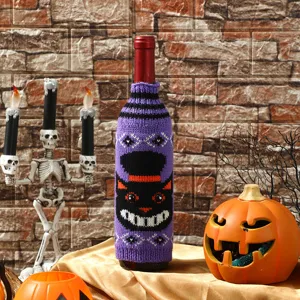 Halloween knitted wine bottle cover featuring spooky cat design for holiday table decor
