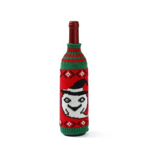 Knitted wine bottle cover featuring spooky ghost pattern, perfect for holiday table decoration.