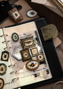 Detailed macro view of vintage 3D insect stickers in ornate frames for journal decoration