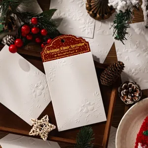Set di carta materiale natalizia goffrata bianca con motivi a rilievo di campane e neve