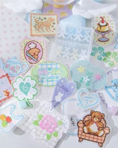 Macro view of various pixel art style transparent stickers for DIY journal decoration