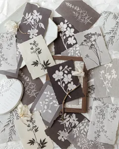 Detailed view of vintage botanical silhouette paper scraps with elegant floral patterns