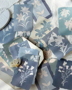 Detailed macro view of vintage botanical floral silhouette scrapbook paper sheets