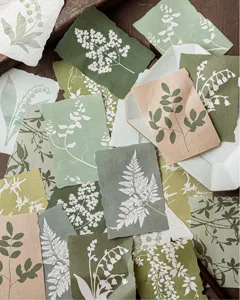 Macro detail of botanical silhouette material paper with fern and leaf patterns for journaling.