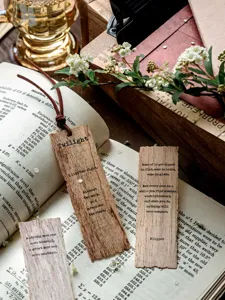 Macro detail of vintage wooden bookmarks with English literary quotes on an old book page