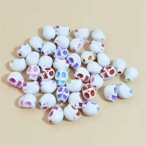 Detailed view of colorful 10-13mm acrylic skull beads for DIY jewelry making.
