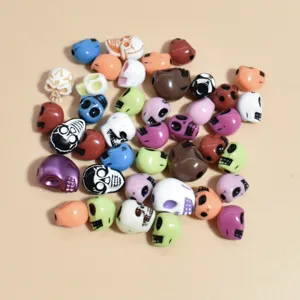 Close-up view of mixed color 10-13mm acrylic skull beads for DIY jewelry accessories