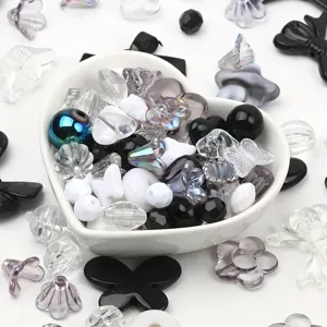 Detailed macro view of mixed acrylic beads in a heart bowl for DIY jewelry making
