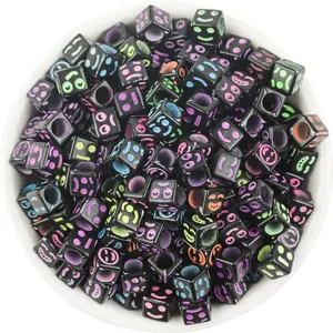 Close-up of 6mm black square acrylic beads with colorful funny facial expressions