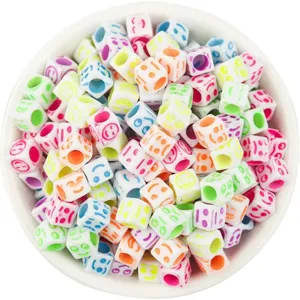 Macro view of colorful 6mm acrylic cube beads featuring various funny emoji faces