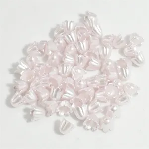 Macro detail of 11mm flower shaped lily-of-the-valley pearl beads for DIY jewelry crafts