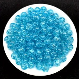 Macro view of blue 8mm crackle acrylic beads for DIY jewelry making and bracelets