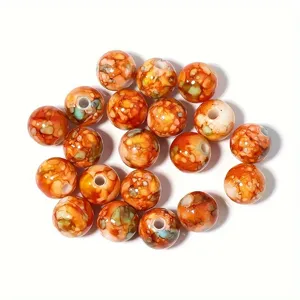 Primer plano de cuentas de acrílico naranja con patrón de estallido 8-10mm para DIY