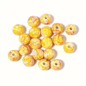 Vista detallada de cuentas de acrílico jaspeado amarillo y rosa 8-10mm para DIY