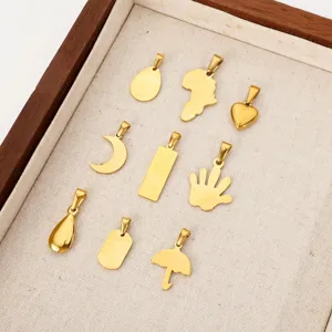 Assorted 18k gold-plated stainless steel DIY charms arranged in a rustic wooden display tray