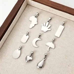 Detailed macro view of assorted stainless steel DIY jewelry pendants and charms
