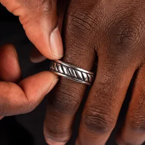 Detailed close-up showing the vintage embossed texture of a men's stainless steel ring