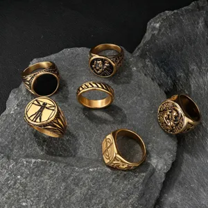 Detailed view of men's vintage relief rings with Da Vinci and religious motifs