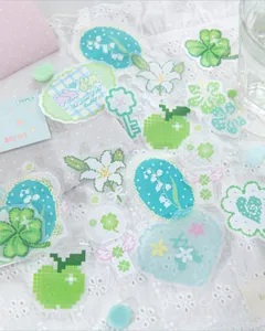 Macro view of various mint green pixel art stickers for DIY scrapbooking and creative planners