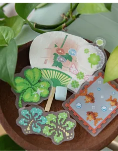 Detail view of pixel art stickers with clover and goldfish designs for DIY journaling