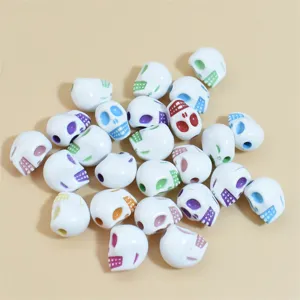 Primer plano de cuentas de calavera de acrílico blanco con acentos coloridos para joyas DIY