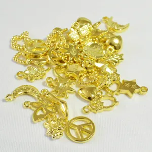 Close-up of mixed gold-plated 16mm DIY charms including stars and peace signs