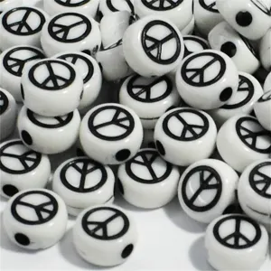 Detailed macro view of white 7mm acrylic beads with black peace symbol designs