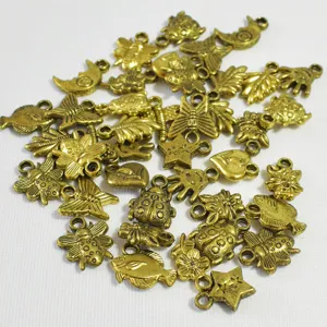 Detail view of various 16mm gold plated metal charms for DIY jewelry making