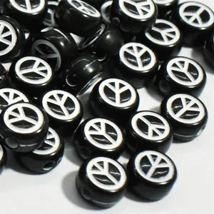 Close-up of black 7mm acrylic beads with white peace symbol for DIY jewelry making.