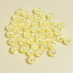 Macro view of 8mm iridescent pale yellow acrylic round beads with shimmering AB finish