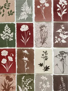 Detailed macro view showing diverse botanical silhouette patterns on vintage decorative paper