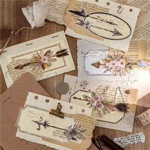Vintage papieren stickers met veren en pijlen voor junk journal decoratie