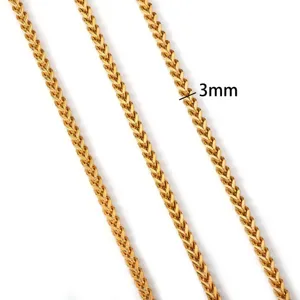 Close-up of 3mm gold stainless steel wheat chain necklace with detailed woven texture
