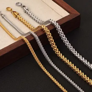 Detailed macro shot of stainless steel wheat chain necklaces in gold and silver