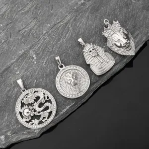 Detailed view of four hip-hop stainless steel pendants with dragon, lion and pharaoh motifs