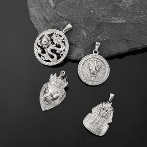 Detail of hip-hop stainless steel pendants featuring dragon, lion, and pharaoh designs.