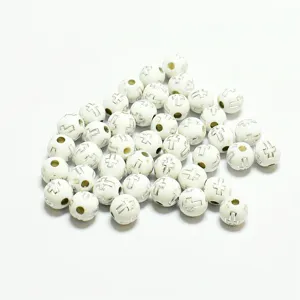 Vue détaillée de perles rondes en acrylique blanc de 8 mm avec croix argentées