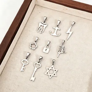 Variety of stainless steel pendants including key, lock, and anchor shapes in tray