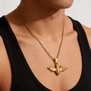 Collier pendentif chauve-souris vintage en acier inoxydable plaqué or 18 carats sur modèle.