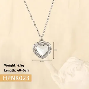 Macro detail of a vintage-style stainless steel heart pendant necklace with shell