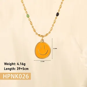 Detail view of golden smiley face pendant with dimension markings and weight specs