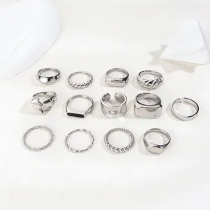 Set of minimalist silver stainless steel rings featuring twist and heart designs